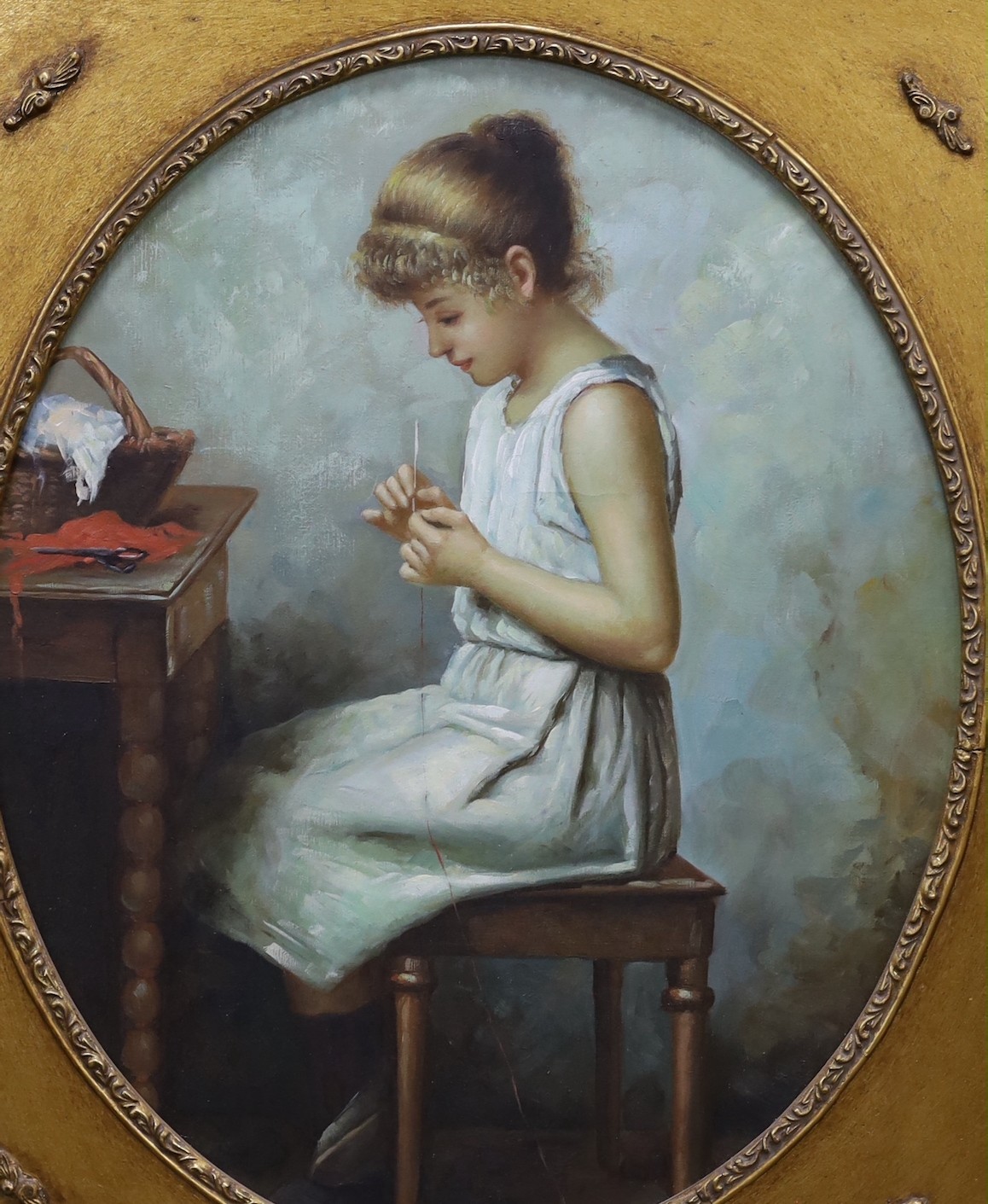 After Alexi Harlamoff (Russian, 1848-1915), oil on canvas, Young girl sewing, framed to the oval 53 x 43cm